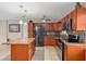 Modern kitchen with a granite island, stainless steel appliances, updated countertops, and tile flooring at 1309 11Th W Ave, Palmetto, FL 34221