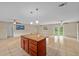Spacious kitchen with tile flooring, island with granite countertop, and modern pendant lighting at 1309 11Th W Ave, Palmetto, FL 34221
