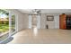 Bright living room with tile flooring, barn doors, and large glass doors to outdoor area at 1309 11Th W Ave, Palmetto, FL 34221