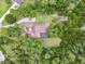 Aerial view of a home surrounded by lush greenery, with a private pool and long driveway at 13503 Gopher Pond Ct, Hudson, FL 34669