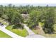 Aerial view of the property with a long driveway leading to a well-maintained home at 13503 Gopher Pond Ct, Hudson, FL 34669