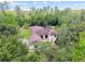 Expansive property featuring lush greenery and a screened-in pool at 13503 Gopher Pond Ct, Hudson, FL 34669