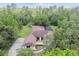 Aerial view of property featuring a spacious layout and serene, wooded surroundings at 13503 Gopher Pond Ct, Hudson, FL 34669