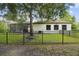 The backyard includes a screened-in patio and is surrounded by a secure black fence at 13503 Gopher Pond Ct, Hudson, FL 34669