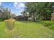Spacious backyard with a disc golf basket, screened enclosure and fenced yard at 13503 Gopher Pond Ct, Hudson, FL 34669