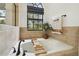 Relaxing bathroom features a soaking tub, decorative tile, and a window with a garden view at 13503 Gopher Pond Ct, Hudson, FL 34669