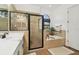 Modern bathroom with a glass-enclosed shower, a soaking tub, and natural light from a window at 13503 Gopher Pond Ct, Hudson, FL 34669