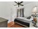 Relaxing bedroom featuring hardwood floors, neutral bedding, and a large window for natural light at 13503 Gopher Pond Ct, Hudson, FL 34669