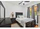 Cozy bedroom with a black wood bed frame, soft blue accents and natural light filtering through the window at 13503 Gopher Pond Ct, Hudson, FL 34669