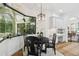 Bright breakfast nook features a black dining set, large window and a built-in serving buffet with mosaic backsplash at 13503 Gopher Pond Ct, Hudson, FL 34669