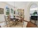 Elegant dining room boasts a chandelier, arched windows, and a built-in china cabinet at 13503 Gopher Pond Ct, Hudson, FL 34669