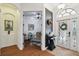Elegant foyer with arched doorway, console table, and seamless transition to the office at 13503 Gopher Pond Ct, Hudson, FL 34669