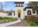 Welcoming home featuring unique tower, arched windows, and inviting walkway at 13503 Gopher Pond Ct, Hudson, FL 34669