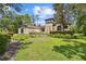 Inviting home featuring unique tower, arched windows, and well-manicured landscaping at 13503 Gopher Pond Ct, Hudson, FL 34669