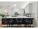 Open kitchen with a large island, modern stools, mosaic backsplash, and stainless appliances at 13503 Gopher Pond Ct, Hudson, FL 34669