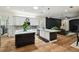 Modern kitchen with a center island, pendant lighting, stainless appliances, and an open layout at 13503 Gopher Pond Ct, Hudson, FL 34669