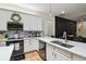 Bright kitchen with quartz countertops, white cabinets, stainless appliances, and mosaic tile backsplash at 13503 Gopher Pond Ct, Hudson, FL 34669