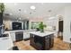 Open kitchen featuring an island with seating, stainless steel appliances, and a view to the dining area at 13503 Gopher Pond Ct, Hudson, FL 34669