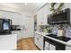 Well-lit kitchen featuring white cabinets, mosaic backsplash, modern appliances, and ample counter space at 13503 Gopher Pond Ct, Hudson, FL 34669