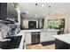 Bright kitchen with stainless steel appliances, white cabinetry, and a view to the living room at 13503 Gopher Pond Ct, Hudson, FL 34669