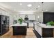 Stylish kitchen featuring quartz countertops, an island, stainless appliances, and ample cabinet space at 13503 Gopher Pond Ct, Hudson, FL 34669