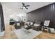 Open-concept space showcases a cozy living room with black accent wall flowing into the adjacent kitchen at 13503 Gopher Pond Ct, Hudson, FL 34669