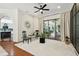 Spacious living room with a plush rug, a ceiling fan, and access to the patio at 13503 Gopher Pond Ct, Hudson, FL 34669