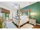 Comfortable main bedroom featuring a four-poster bed, an area rug, and natural light at 13503 Gopher Pond Ct, Hudson, FL 34669