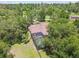 Home with an enclosed private screened in pool, nestled among the trees at 13503 Gopher Pond Ct, Hudson, FL 34669