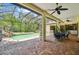Inviting pool and spa area with covered patio offering serene views of surrounding greenery at 13503 Gopher Pond Ct, Hudson, FL 34669