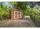 Durable outdoor shed with double doors, painted in neutral tones with white trim at 13503 Gopher Pond Ct, Hudson, FL 34669