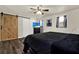 Bedroom with dark-wood floors, a ceiling fan, barn door closet and modern decor at 1359 S Michigan Ave, Clearwater, FL 33756
