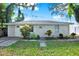 Charming single-story home featuring white trim, flowering bushes and a well-manicured lawn at 1359 S Michigan Ave, Clearwater, FL 33756