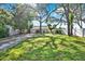 A beautiful lawn and large shade trees adorn the home's front yard at 1359 S Michigan Ave, Clearwater, FL 33756