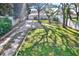 Expansive front yard with a gravel driveway and mature trees providing ample shade at 1359 S Michigan Ave, Clearwater, FL 33756
