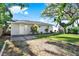Charming home with a well-manicured front yard and gravel driveway at 1359 S Michigan Ave, Clearwater, FL 33756