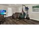 Comfortable living room with wood-look floors, a stylish hammock chair, and plenty of natural light at 1359 S Michigan Ave, Clearwater, FL 33756