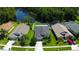 Beautiful aerial view of a home adjacent to a lake with lush green landscaping at 14427 Pepperpine Dr, Tampa, FL 33626