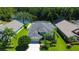 Scenic aerial view showcasing a home with a fenced yard, screened-in patio and adjacent lake at 14427 Pepperpine Dr, Tampa, FL 33626