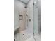 Luxurious bathroom shower with rainfall shower head, mosaic floors, and a built-in bench at 14427 Pepperpine Dr, Tampa, FL 33626