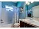 Well-lit bathroom with a shower-tub combination and dark-wood vanity with sink at 14427 Pepperpine Dr, Tampa, FL 33626