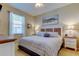 Inviting bedroom with neutral walls, ceiling fan, a large window and coastal-themed decor at 14427 Pepperpine Dr, Tampa, FL 33626