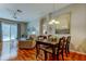 Dining room with hardwood floors, slider to pool, and open concept floorplan at 14427 Pepperpine Dr, Tampa, FL 33626