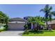 Charming single-story home featuring mature landscaping and a well-manicured lawn at 14427 Pepperpine Dr, Tampa, FL 33626