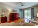 Cozy living room with gleaming hardwood floors and a view of the pool through sliding glass doors at 14427 Pepperpine Dr, Tampa, FL 33626