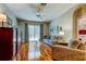 Inviting living room featuring hardwood floors, neutral tones, and sliding glass doors to the pool area at 14427 Pepperpine Dr, Tampa, FL 33626