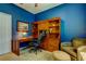 Home office featuring a built-in wooden desk, ample shelving, and comfortable seating, perfect for productivity at 14427 Pepperpine Dr, Tampa, FL 33626