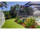 Screened pool area featuring lush landscaping and a backyard pond view offers a relaxing outdoor space at 14427 Pepperpine Dr, Tampa, FL 33626