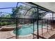 Screened pool area with an attached hot tub, fully enclosed for safety and relaxation at 14427 Pepperpine Dr, Tampa, FL 33626