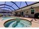 Inviting screened-in pool and spa area with an outdoor seating area at 14427 Pepperpine Dr, Tampa, FL 33626